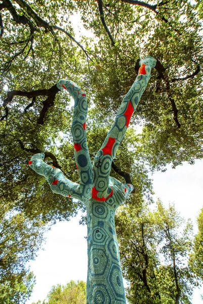 Artist Yarn Bombing by Accademia Aracne with his knitted trees  at the exhibition 'Back to nature' 2021, installations of contemporary artists in Villa Borghese in Rome , June 13, 2021 in Rome, Italy, Europe