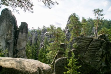 Çek Cumhuriyeti 'nde kumtaşı oluşumları ve huzurlu bir dağ gölü olan Adrspach Kayaları. Manzaralı kaya manzarası, berrak su yansımaları ve Orta Avrupa 'nın doğal harikası..