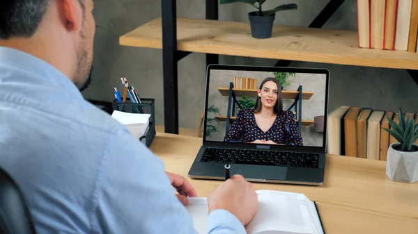 Woman tutor in computer screen teaches by remote web cam, distance education