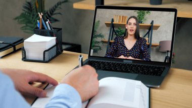 Laptop ekranındaki kadın öğretmen uzak web kamerası ve uzaktan eğitim ile öğretiyor.