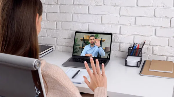 Man tutor in computer screen greets teaches by remote webcam, distance education