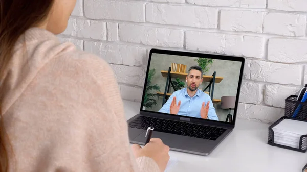 Man teacher in laptop screen speak teaches by remote webcam, distance education