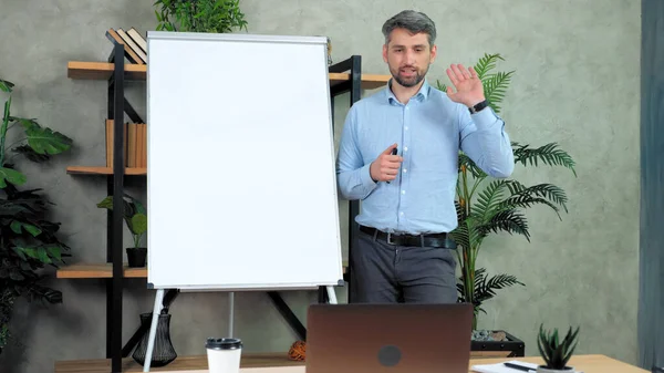 Business man coach near whiteboard greets talk listen teaches online video call — Stock Photo, Image
