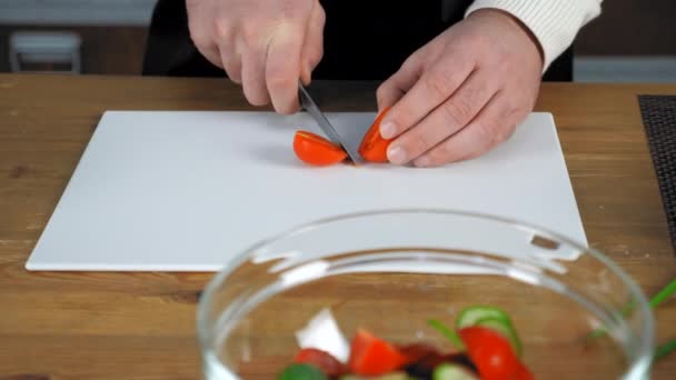 Chef cook man standing near table sliced fresh cherry tomato in home kitchen — Stock Video