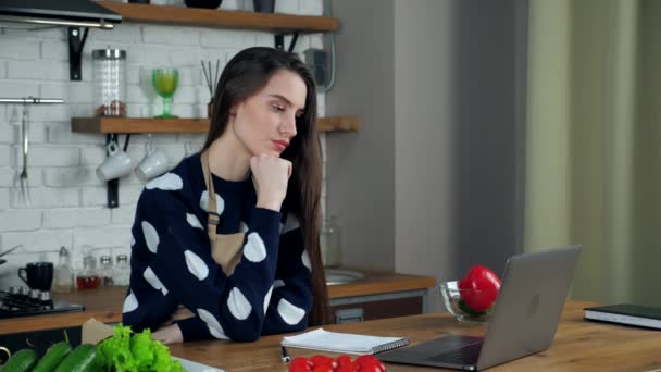 Mulher pensativo estudo on-line vídeo chamada webcam laptop webinar curso na cozinha — Vídeo de Stock