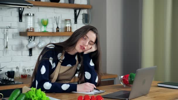 Wanita lelah tidur duduk di kursi di meja dapur, belajar video online laptop — Stok Video