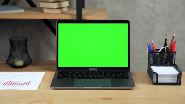 Laptop mit grünem Bildschirm steht auf Tisch — Stockvideo