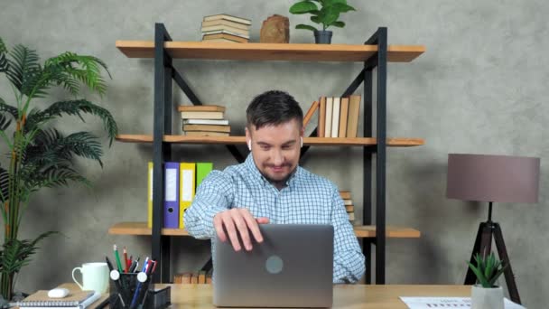 Mosolygós férfi üzleti edző ül a széken az asztalnál nyitva, és elkezd használni laptop — Stock videók