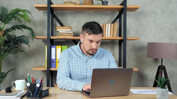 Businessman using types on laptop keyboard searches information on internet