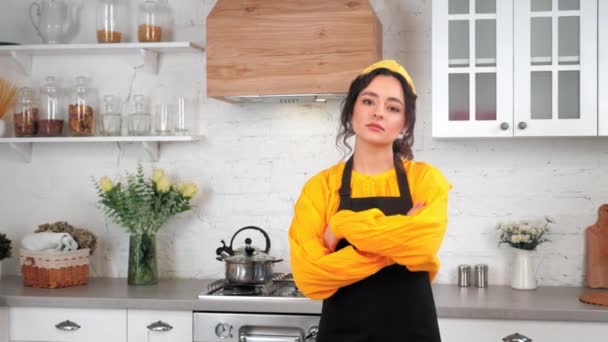 Portrait serious housewife crossing hands looking camera in home modern kitchen — Stock Video