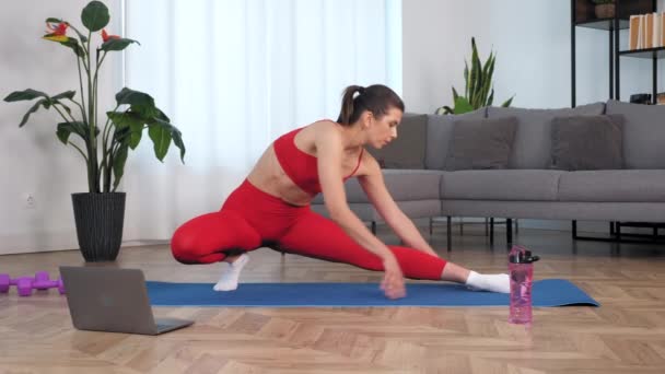 Fit mulher assistir online esporte webinar laptop, fazendo aquecimento alongamento treinamento — Vídeo de Stock