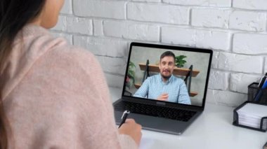 Businessman in computer screen tells tasks top manager online video call laptop