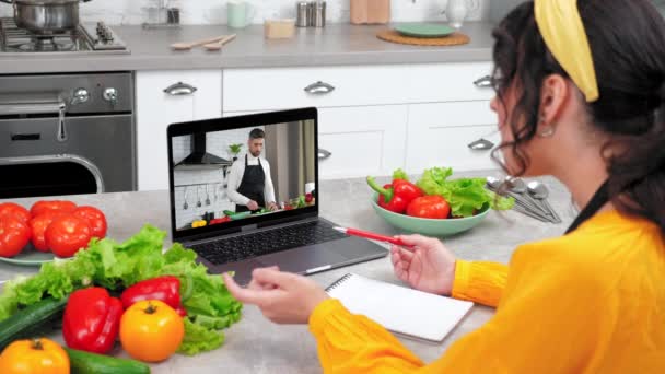 Woman in home kitchen study online video call webcam laptop tells teacher chef — Stock Video