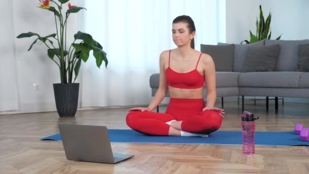 Mujer en forma deportiva sentada en la estera de yoga bailando hace ola con las manos en casa — Vídeo de stock