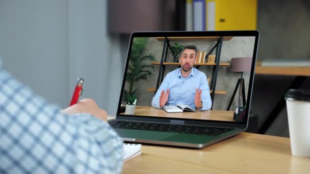 Man business coach in laptop computerscherm vertelt doceert business student — Stockvideo