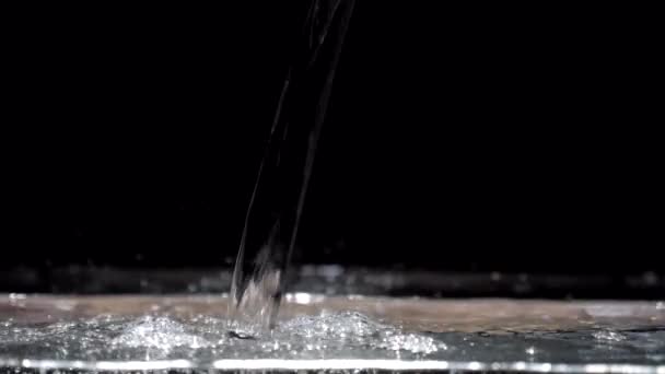 Flux d'eau à mouvement lent descend dans l'aquarium sur un fond noir — Video
