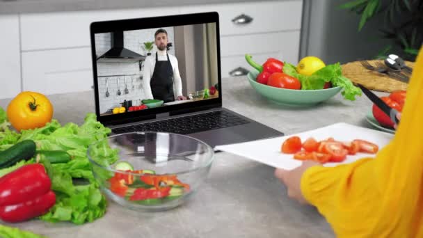 Mulher em facas de cozinha de tomate fatiado de tábua de corte em tigela de salada de vidro — Vídeo de Stock