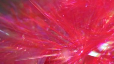 Parlak kırmızı metalik tatil soyut arka planı. Gökkuşağı ışınlı bir ışık demeti