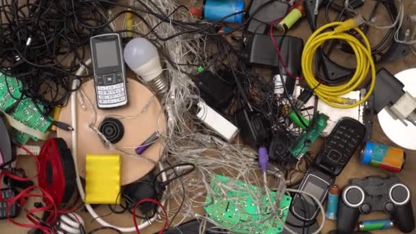 E-waste and Hazardous waste sorting and disposal. Old broken phones, battery, computers and electronics. Heavy metal pollution. Used electrical devices and obsolete electronic equipment — Stock Video