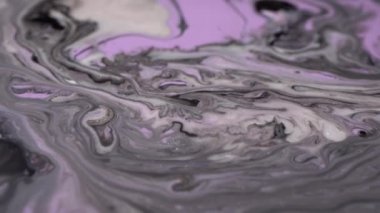 Mor, pembe, eflatun, gümüş, parlak, beyaz inci renkleri karışımı. Boyama hareketi makrosu. Mürekkep akışı. Parıldayan sıvı hareketi. Akan sıvı boya akışı. Güzel soyut arkaplan