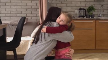 Evinde annesine sarılan üzgün bir kız. Esmer Anne 'nin Çocuğuyla Bakışı, Hayal kırıklığına uğramış Yüzü Evde Genç Bir Kadın Kucaklıyor