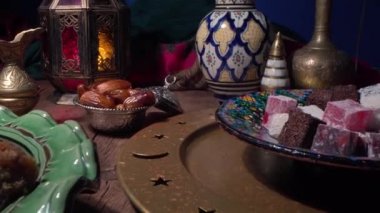 Traditional Oriental Arabic sweets, dates, nuts and fruits. Muslim holiday table setting close up. Ramadan Night