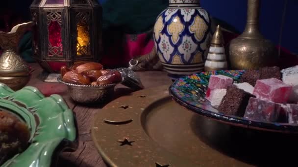 Traditional Oriental Arabic sweets, dates, nuts and fruits. Muslim holiday table setting close up. Ramadan Night — Vídeo de Stock