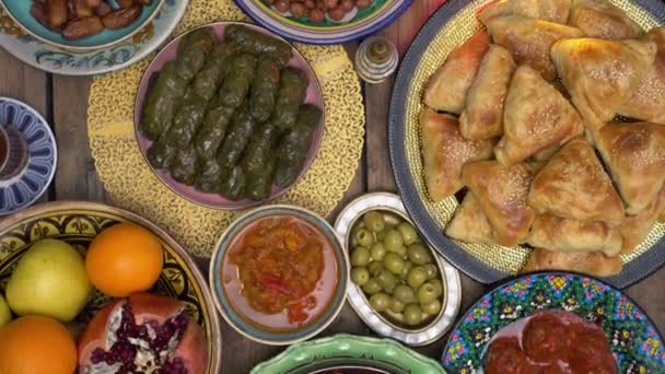 Muslim holiday Eid al-Adha, Feast of the Sacrifice table setting top view. Traditional Halal meals of sacrificial meat and oriental sweets — Vídeo de Stock