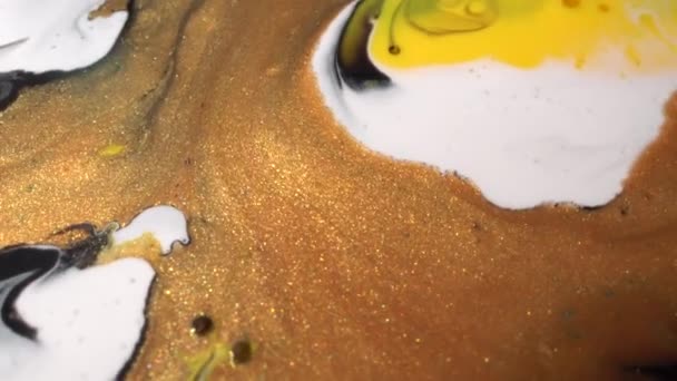 Yellow, white, black and gold color ink mix. Texture of liquid marble. Fluid Art painting. Moving flowing stream of paint. Decorative shiny abstract background — Stock videók