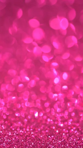 Rosa Glitter bakgrund. Magiskt damm, glänsande konsistens, semesterljus, flygande partiklar bildar en vacker bokeh. Glänsande festlig jul bakgrund. Vertikal — Stockfoto