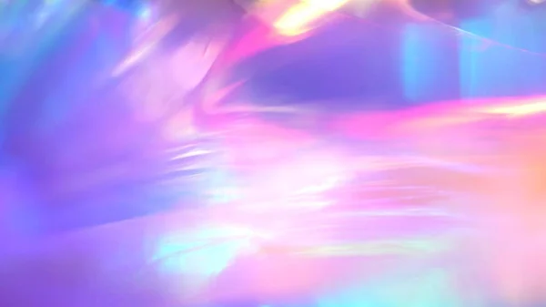 A holographic rainbow unicorn pastel purple pink teal colors abstract background. Optical crystal prism flare beams. Light flares. Christmas texture