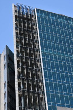 Elements of the facade of the city building, built of glass and concrete 