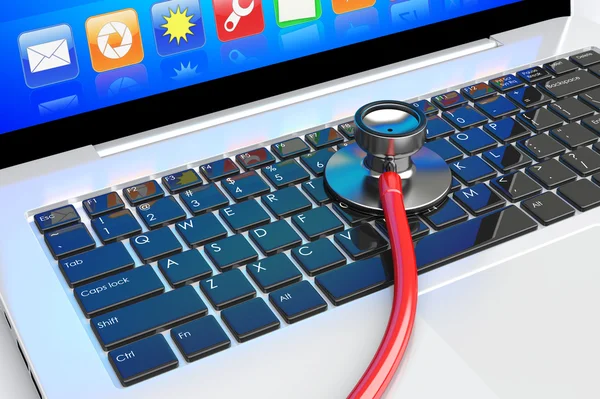 Stethoscope lying on laptop — Stock Photo, Image