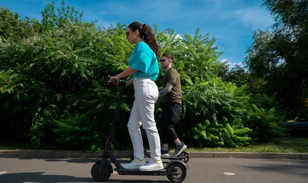 Young Couple Driving Electric Scooters City Park — 图库照片