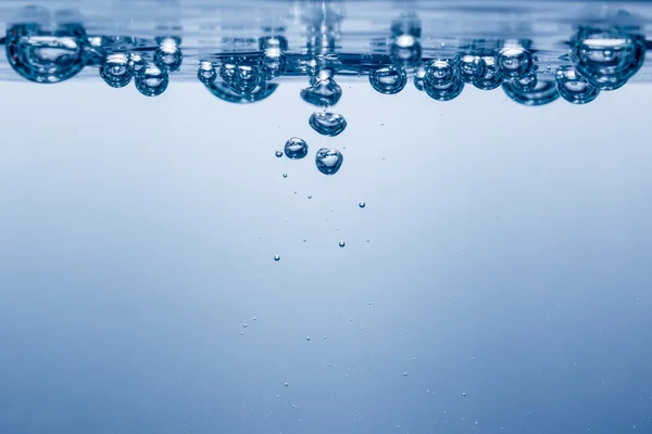 Blue bubbles after a splash in the water. Close-up. Under water Stock Picture