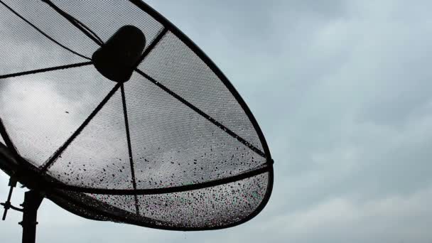 Satellite Dish on cloudy sky background with water drop — Stock Video