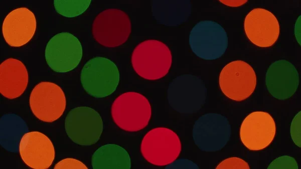 bright bokeh from garlands on dark background. New year or Christmas backdrop