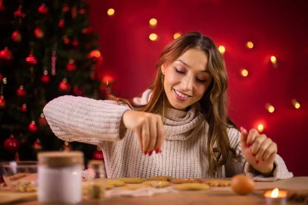 Horneado de Navidad. bastante sonriente joven mujer decoración de galletas de Navidad — Foto de Stock