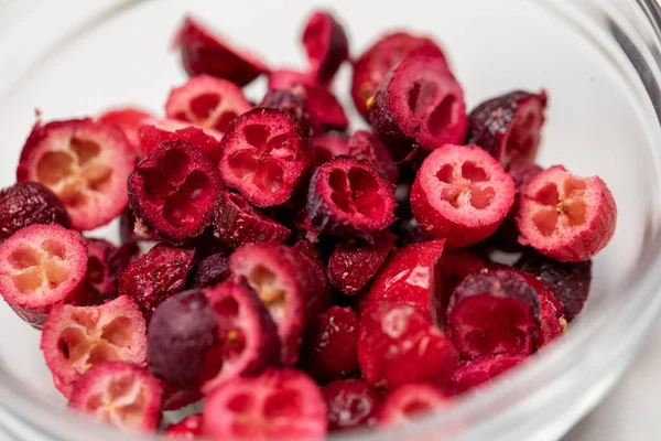 Closeup freeze-dried organic cranberry berries pieces in glass bowl natural food — Stock Photo, Image