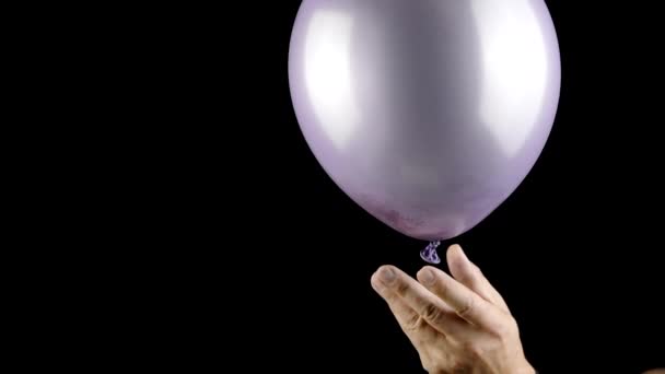 Balloon burst in slow mo, golden glitter confetti explosion on black background — Stock Video