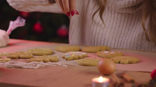 Dekorieren frisch gebackener Lebkuchen mit bunten essbaren Zuckerstreusel — Stockvideo