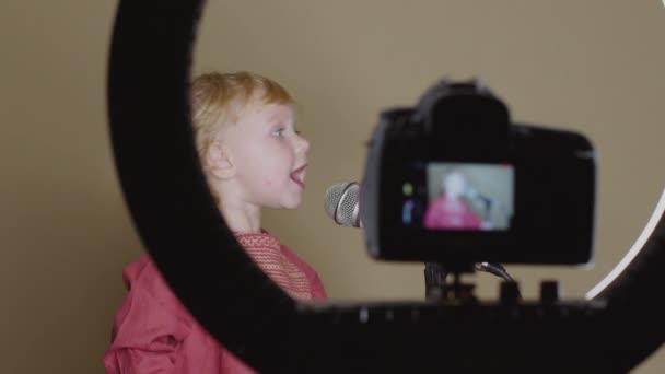 Cute little girl sing song into microphone, funny toddler enjoing broadcasting — Stock Video