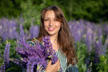 Mutlu gülümseyen, kendine güveni tam bir kız kameraya bakıyor..