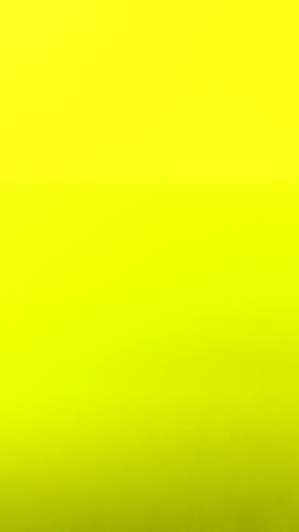 Vertical video Drop of water falls on surface of liquid in slow motion. Yellow background macro — Stock Video