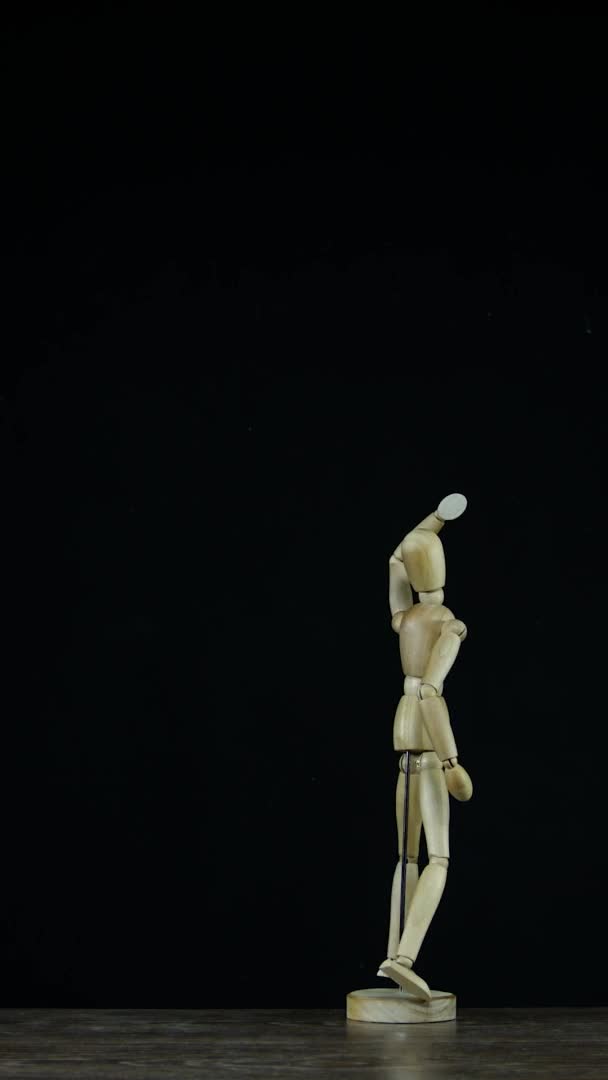 Vídeo vertical Maniquí figura de madera Stopmotion en estudio sobre fondo negro — Vídeo de stock