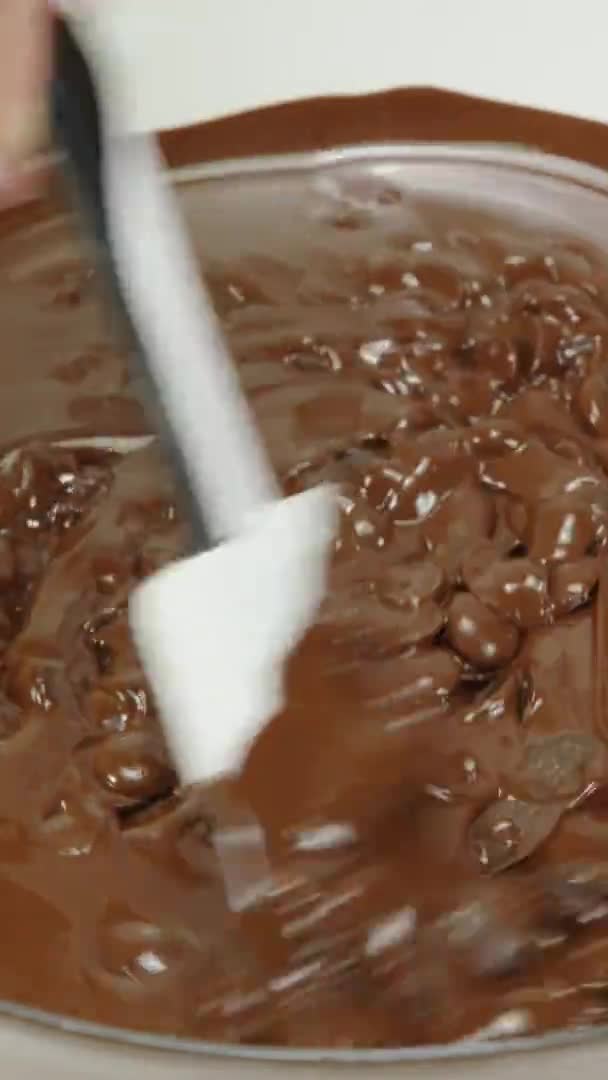 Vertical shot Closeup stirring mixing dark melting chocolate in glass bowl, slow motion — Stock Video