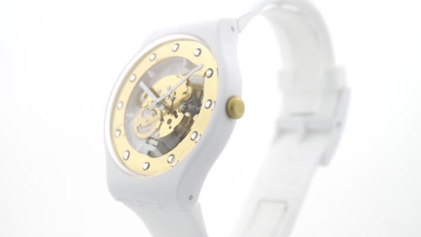London, UK, 01.11.2020 Swatch white plastic watch turning on stand — стокове відео