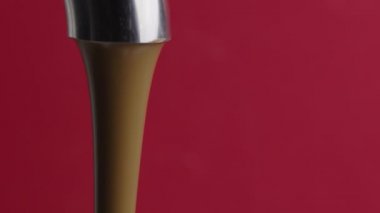 Erimiş çikolata jeti ya da parlak metal musluktan akan sıvı karamel.