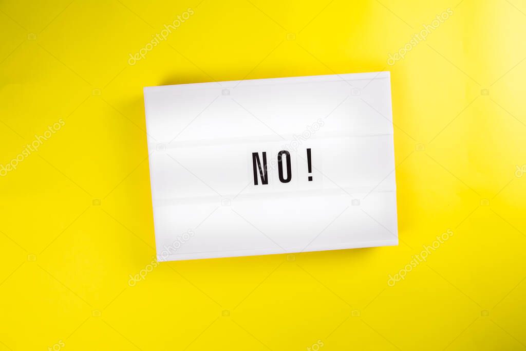 Lightbox with text NO isolated on yellow background, danger, ban, stop, embargo