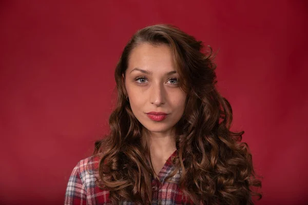 Close-up encantadora mujer confiada mira a la cámara en el fondo rojo, Espacio de copia — Foto de Stock